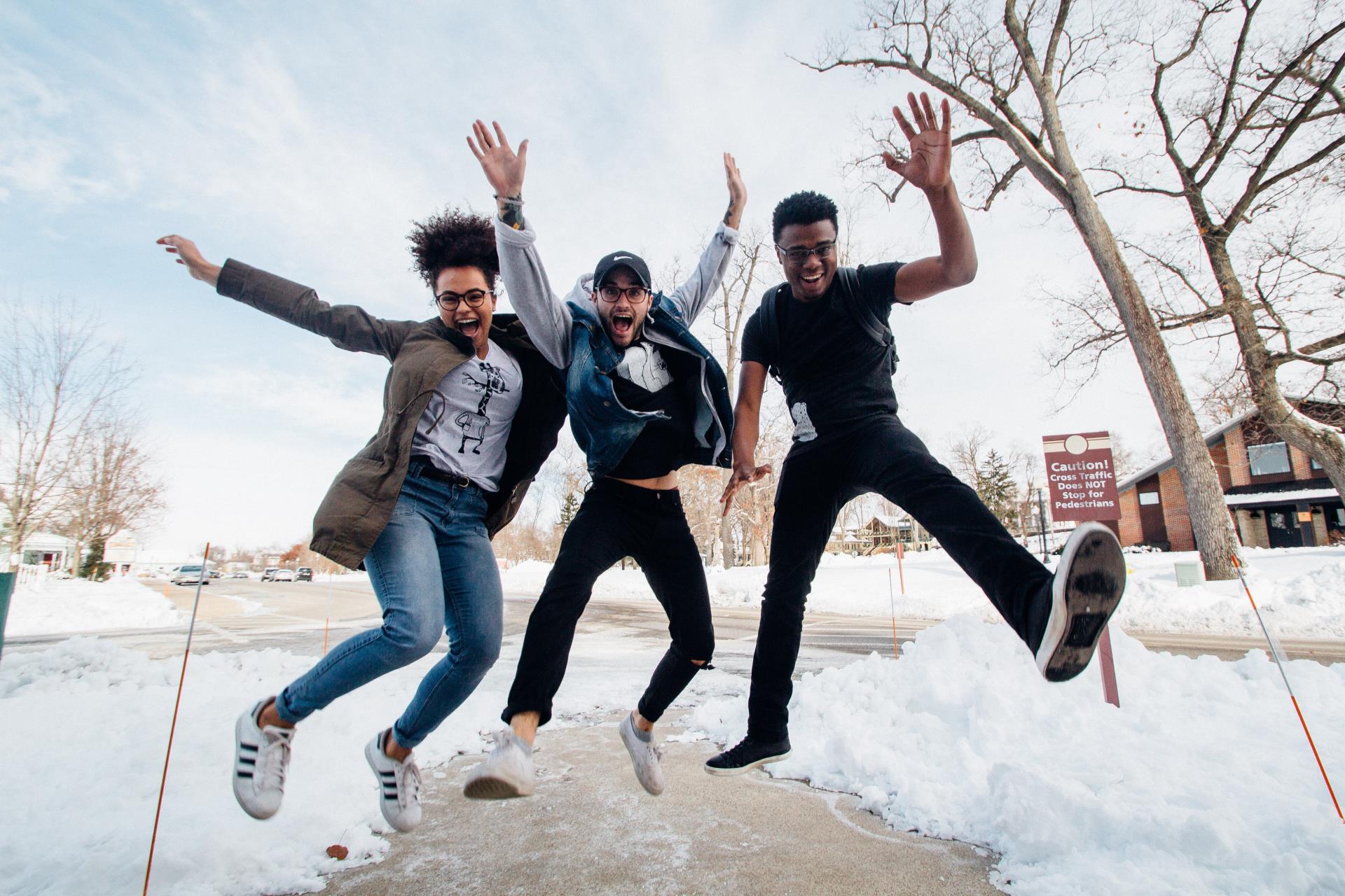 high school students jumping in the snow