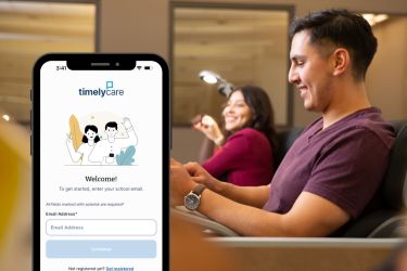 timelycare on mobile to the left of GCC students on campus